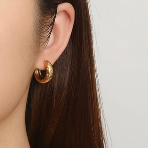 French vintage gold hoop earrings with star-shaped diamonds on a model's ear