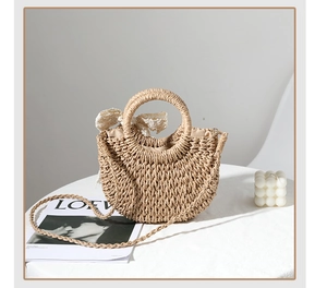 Detail of woven straw bag with delicate lace bow and braided strap for beach style