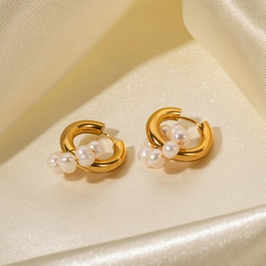 Detailed shot of gold stainless steel hoop earrings with natural freshwater pearl clusters