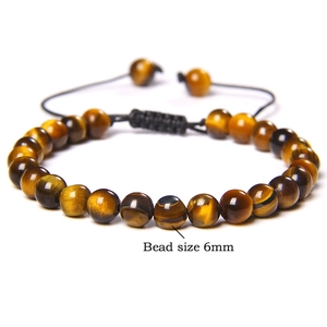 Detail of 6mm tiger eye stone beads on an adjustable hand-woven braided cord bracelet