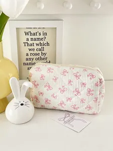 Pink bow printed quilted cotton makeup bag for women with floral desktop background