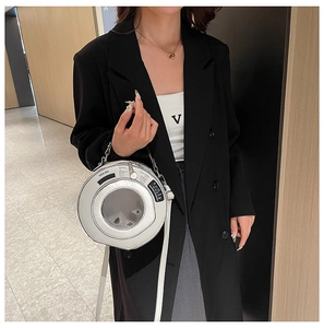 Detailed view of silver creative washing machine shaped handbag with a transparent window