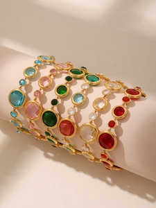 Detail view of colorful Czech glass bracelets on display with golden metal chains