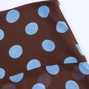 Detail of brown skirt with blue polka dots showing the side invisible zipper closure