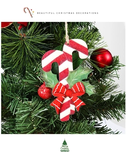 Detail of wooden candy cane ornament with red bow on a festive Christmas tree