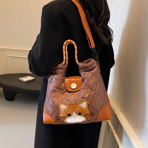 Brown quilted puffer tote bag with cat plush decoration and woven handles