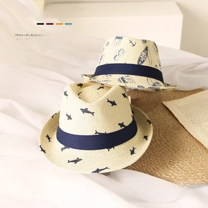 Detail of kids straw fedora with blue ocean patterns and shark motif for summer sun protection