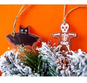 Halloween bat and skeleton gingerbread man tags with twine on orange festive background