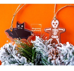 Halloween bat and skeleton gingerbread man tags with twine on orange festive background