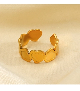Close-up of adjustable 18K gold plated ring with beige enamel heart-shaped pattern