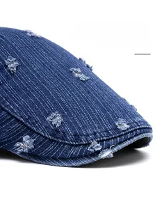 Detailed macro of vintage denim beret featuring distressed holes and flexible wide brim