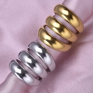 Polished 304 stainless steel curved rings in gold and silver finish on pink silk base