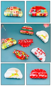 Detail view of festive Christmas hair claw clips with reindeer and gingerbread patterns