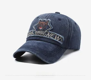 Close-up of vintage embroidery and stitching details on a washed navy baseball cap