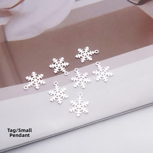 Macro shot of seven S925 sterling silver snowflake charms for DIY jewelry making