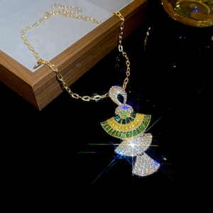 Detail of a luxury gold-tone necklace with layered fan-shaped pendants and colorful crystals