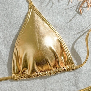 Detail of metallic gold bikini top with drawstring triangle cups and shimmer fabric