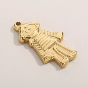 Detailed close-up of a gold-plated cartoon girl pendant with polished metallic finish
