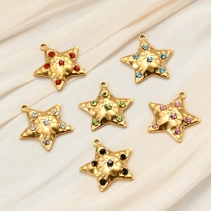 Vintage stainless steel star pendants with colorful rhinestones on silk background