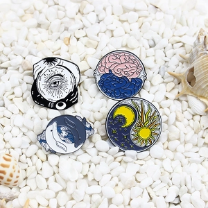 Artistic enamel pins set featuring mystical eye, brain, whale, and sun moon designs