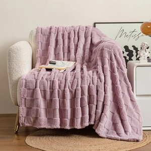 Detail of lavender checkerboard faux fur blanket draped on a modern white sofa