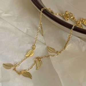 Minimalist 925 sterling silver leaf anklet with golden finish on white background
