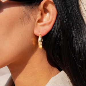 Detailed view of 18k gold plated teardrop earrings with a high-polished mirror finish