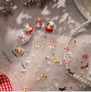 Detailed view of New Year nail stickers with red horse, fireworks and gold star patterns