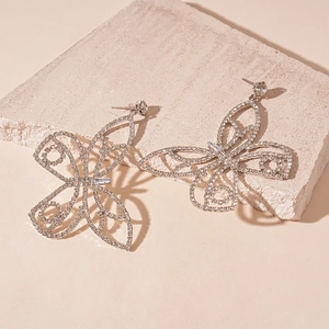 Macro shot of silver butterfly drop earrings with sparkling pavé cubic zirconia details