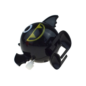 Close-up of wind-up black bat toy for Halloween featuring round body and white knob