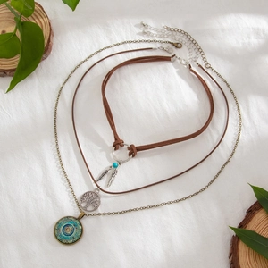 Bohemian multilayer necklace with Evil Eye, Tree of Life and feather pendants in bronze