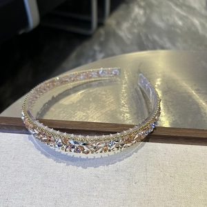 Close-up of Baroque crystal headband featuring amber rhinestones and gold metal details