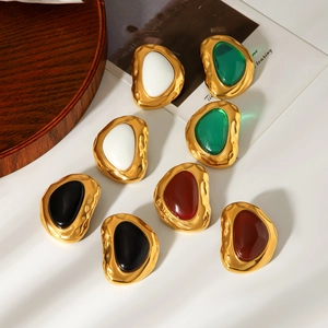 Detail showing vintage irregular 18k gold earrings with colorful resin stone inlay
