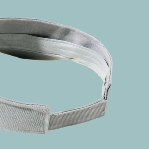 Detailed view of adjustable gray fabric strap and fine stitching on the sun visor hat