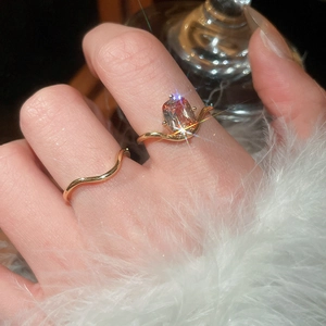 Detail of 18k gold plated wave rings set with rectangular zircon stones on a model