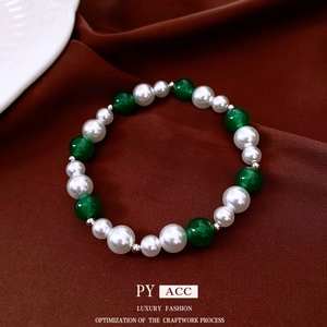 Vintage style bracelet featuring alternating white pearls and green agate beads on fabric
