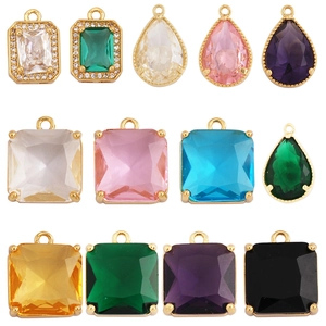 Assorted gold-plated geometric pendants with multi-color cubic zirconia in a grid layout