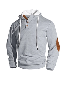 Close-up of gray waffle texture hoodie featuring brown buttons and elbow patches