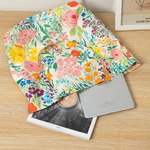 Floral canvas tote bag showing interior capacity with a tablet and magazine