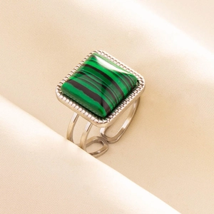 Macro detail of a 304 stainless steel ring with square green malachite and silver texture