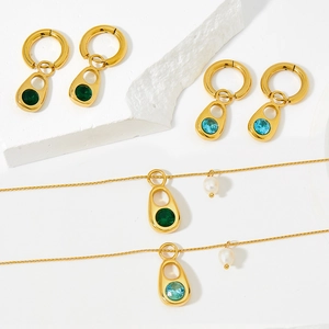 Gold stainless steel jewelry set with green and blue gemstones and elegant pearls