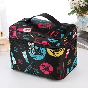 Large black satin cosmetic bag with rose floral print and sturdy handle for travel storage
