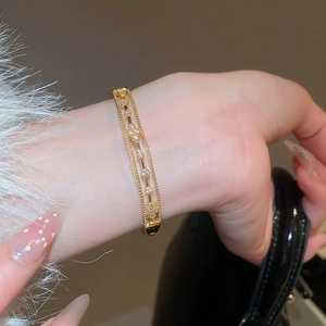 Detailed macro view of 18k gold plated bangle with sparkling cubic zirconia inlay