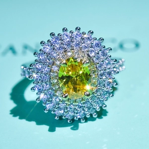 Macro view of luxurious oval yellow-green gemstone ring with double halo diamond setting