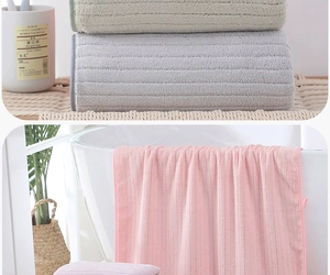 Detail of soft coral fleece bath towel with vertical stripes texture in pastel colors