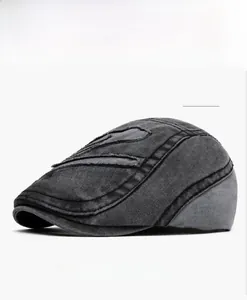 Detail of vintage washed cotton flat cap featuring Boston embroidery and distressed edges