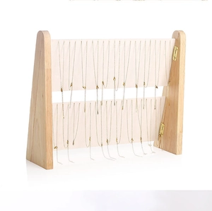 Two-tier wooden and beige velvet necklace display stand for organized jewelry storage