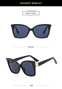 Detail view of stylish black cat-eye sunglasses with luxury gold metal hinges