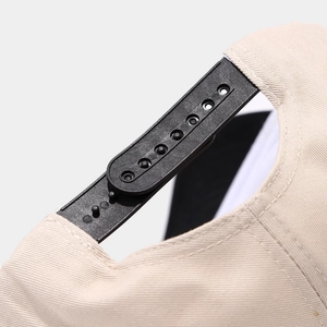 Detail of adjustable double-row plastic buckle on back of contrast baseball cap