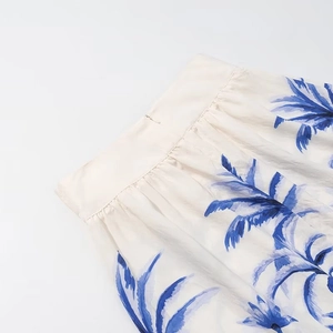 Detail of waist tailoring on blue palm leaf print skirt with invisible zipper closure